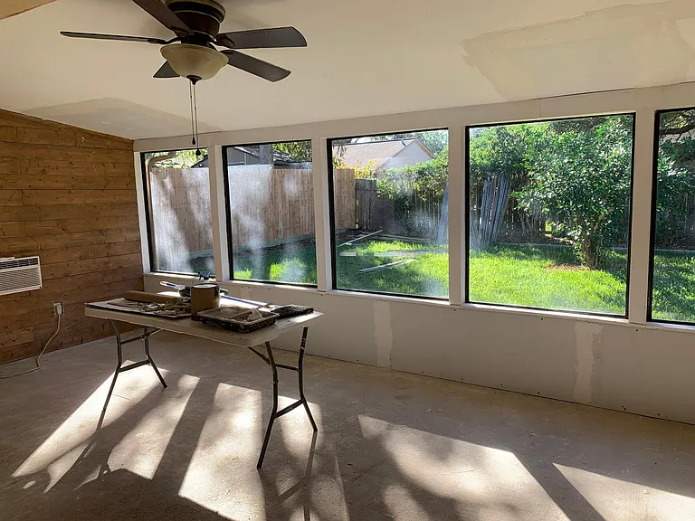 Sunroom or bonus room. It has window AC unit. Ceiling is in process of being textured and painted.