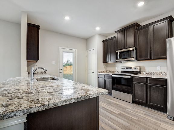 The kitchen comes with a full suite of energy-efficient appliances
