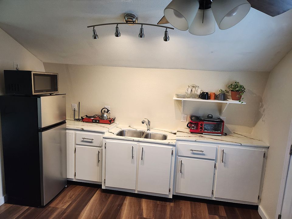 kitchen comes with appliances, cook ware, plates, pots pans, cups and glasses