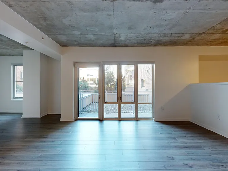 Apartment living room with wood-style flooring.