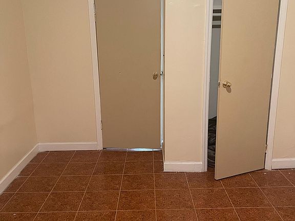 inside one of the bedrooms ( closet on the right) Door on the left