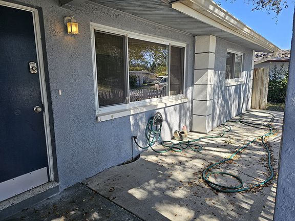The front porch provides outdoor living and leads to the back yard.