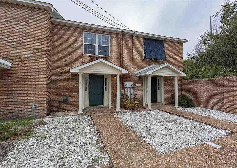 The property is on the left, dark green door.