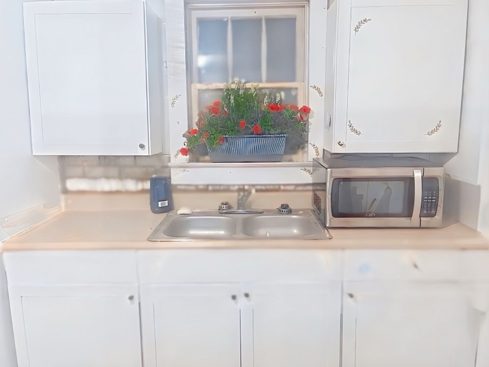 Kitchen with microwave, stove, and refrigerator