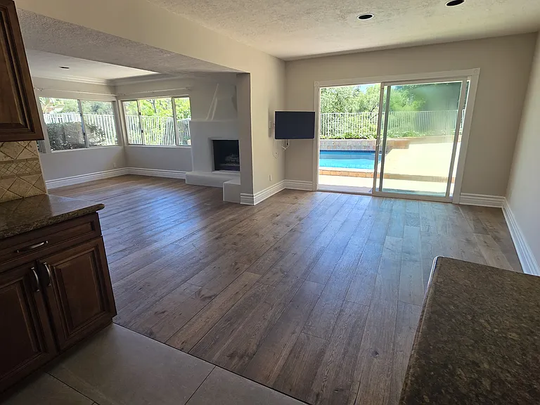 View of dining area and living room off of kitchen.