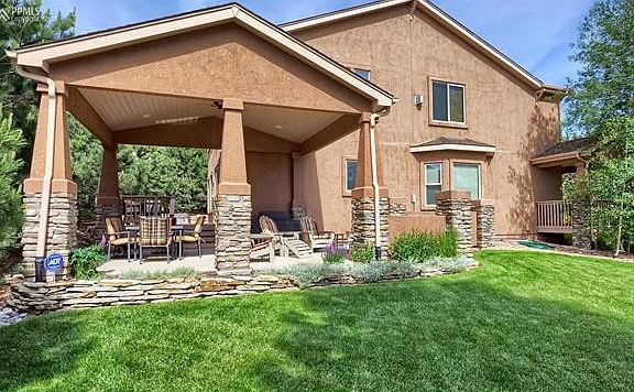 What a nice and inviting covered patio with mountain views.