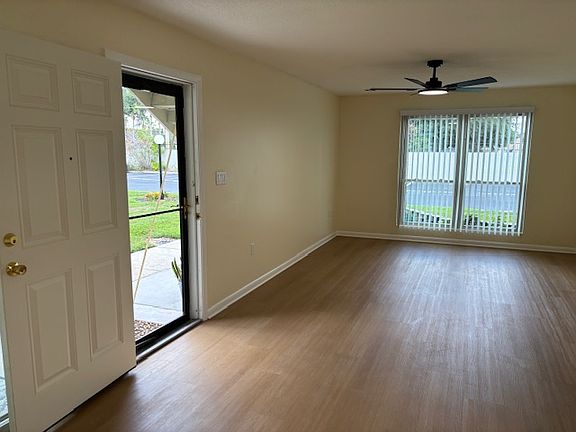 Living room showing front door; offers secure glass door for view and extra natural light