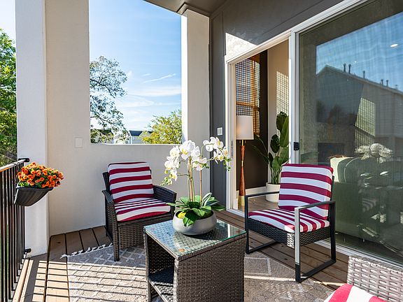Enjoy a relaxing time on the balcony right outside of the living room/kitchen