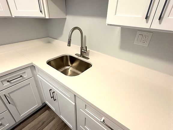 WHITE QUARTZ COUNTERS AND STAINLESS STEEL UNDERMOUNT SINK
