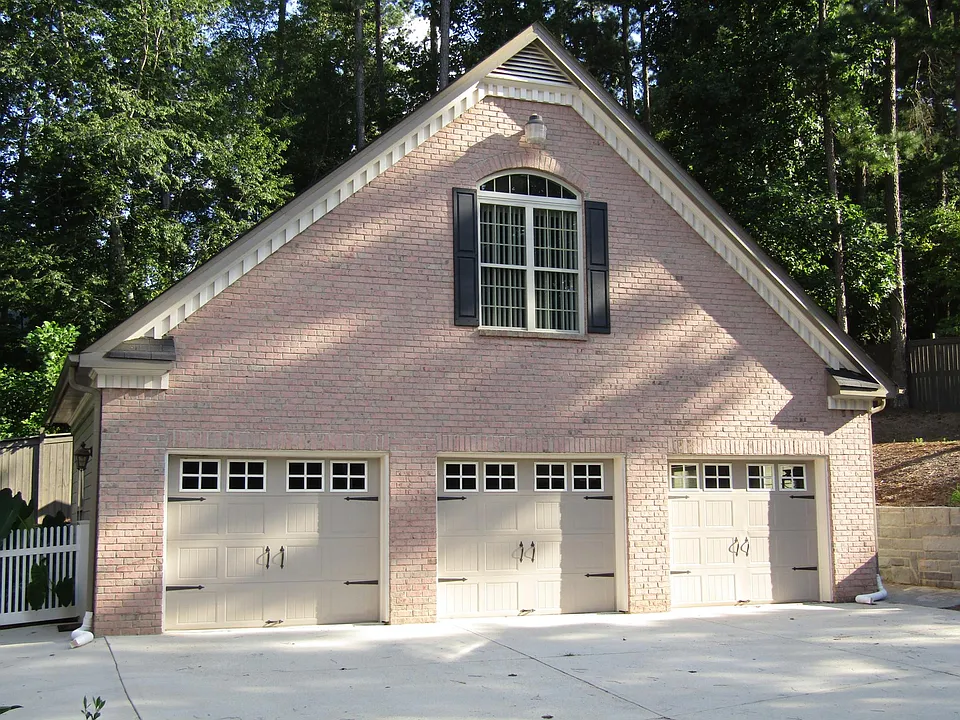 Parking in front of third garage bay, sidewalk to unit on the right.