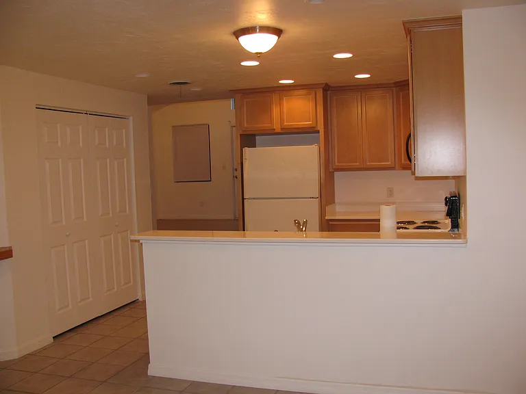 View from dining area into kitchen-now has stainless steel appliances
