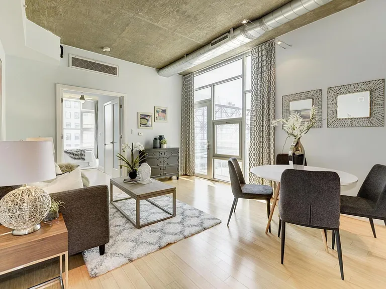View from master bedroom into open concept living room and kitchen
