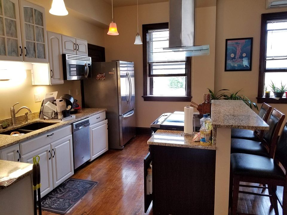 View of kitchen with cooking island and breakfast bar