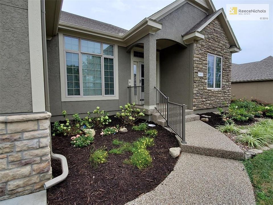 Pebbled walkway to the front porch. Freshly laid landscape in front with rock and mulch. Exterior painted August 2019.
