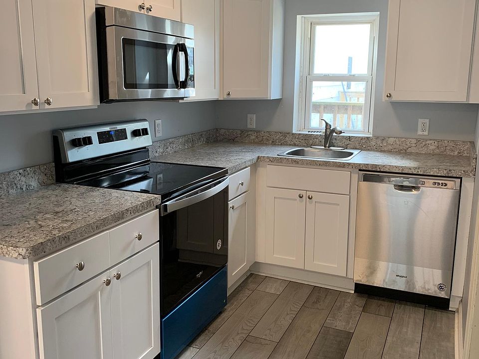 Modern style kitchen with brand new appliances, counter top, and cabinets!