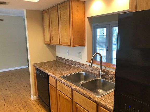 Kitchen opening overlooks sitting area. Doors to screen patio / pool area.