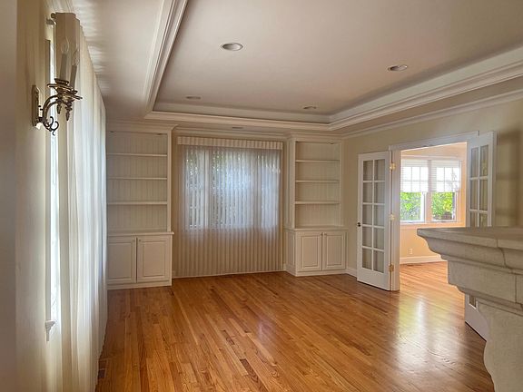 Living room on left of foyer with built in bookcases