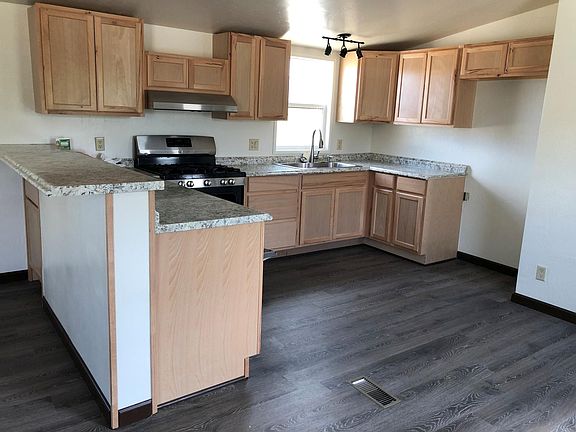 New kitchen with breakfast bar. There is a refrigerator now