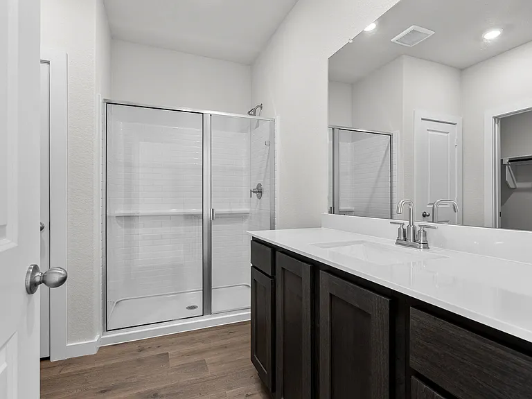 The master bathroom has a glass, walk-in shower.