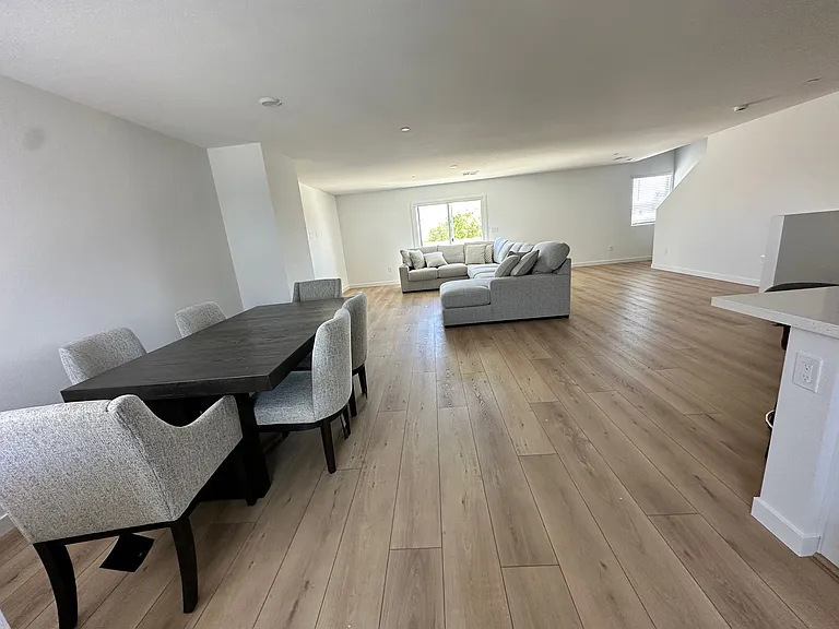 Large Dining and living room with balcony at far end