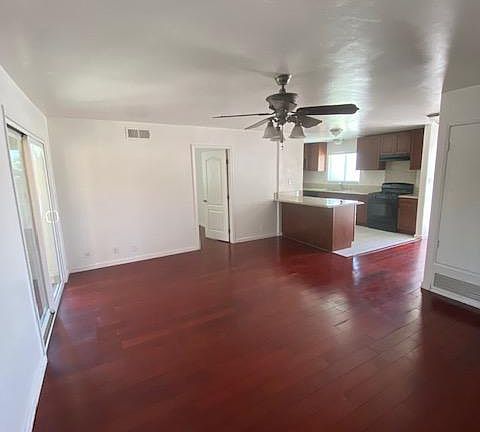View from secondary bedroom hallway to living room and kitchen
