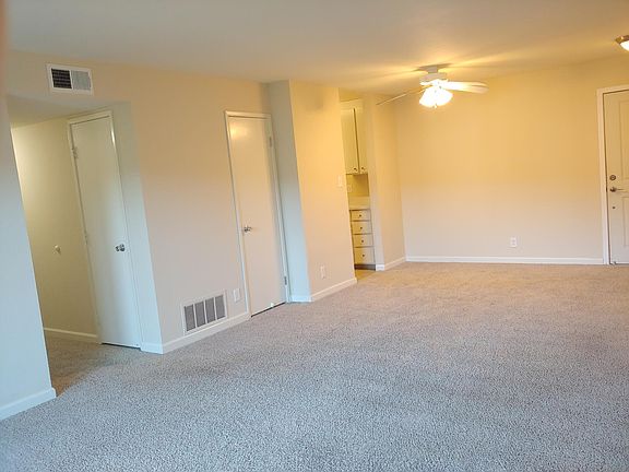 The hallway, coat closet, and kitchen entry (on the left; front door far right.)