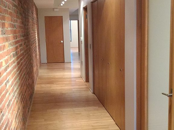 The entrance is a well lit with brick on one side.