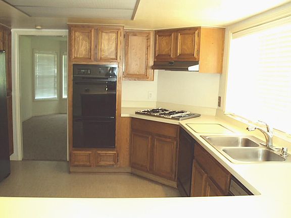 View of the spacious kitchen featuring plenty of cabinetry.