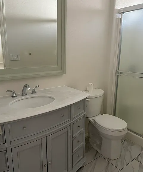 Primary bathroom with stand-up shower; off of primary bedroom