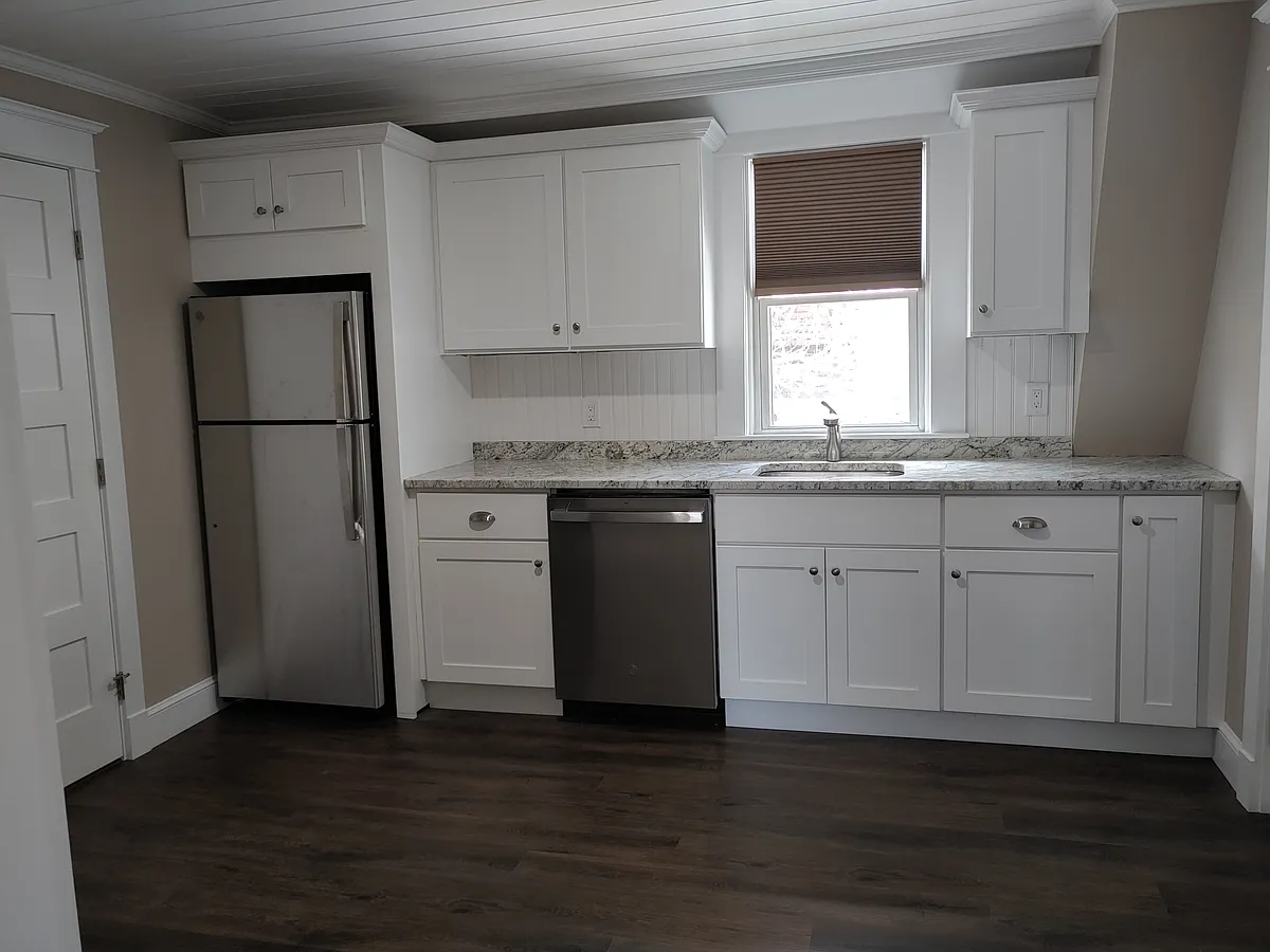 spacious kitchen with stainless appliances and granite countertops - 9 Cleveland St #2N
