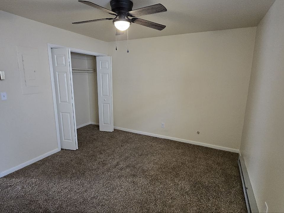 Bedroom with new carpet and ceiling fan.