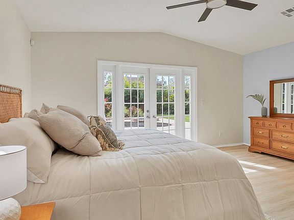 Primary bedroom that opens up to and views the pool.