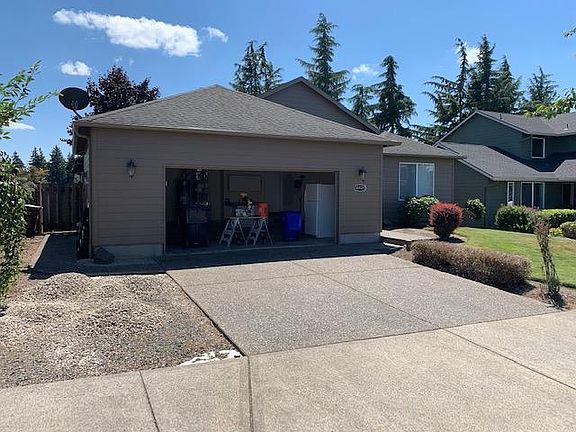 2 1/2 car garage with work bench, utility sink, storage cabinets and refrigerator