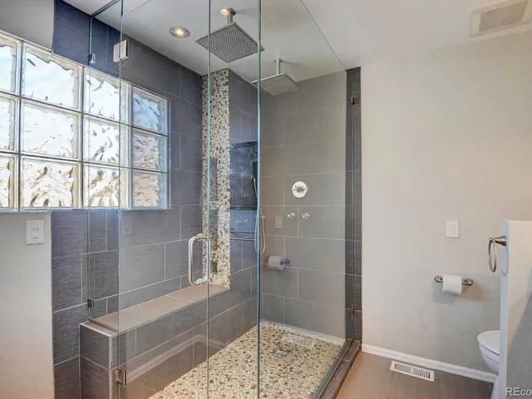 Glass Primary shower with dual rain heads