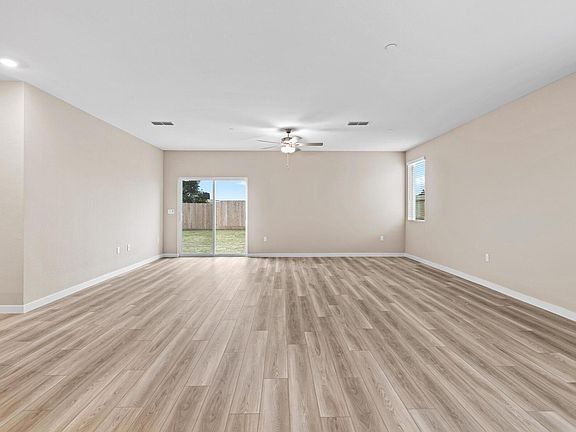 The family room is spacious with a ceiling fan.