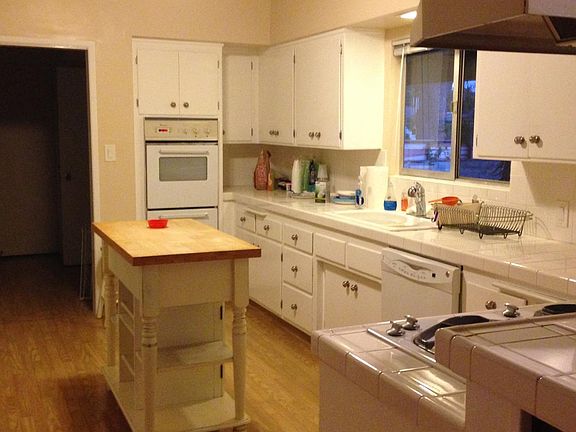 Large open kitchen with view into yard and access to laundry