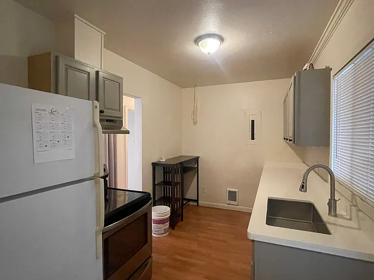 Kitchen with fridge, stove and dishwasher.