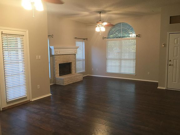 Large living room with wood-burning fireplace.