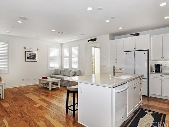 Kitchen opens to great room area - custom plantation shutters and beautiful wood floors