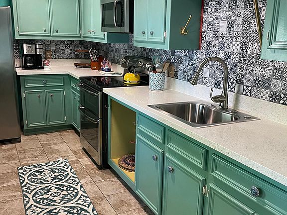 Kitchen with Moroccan blue tile and quartz countertops
