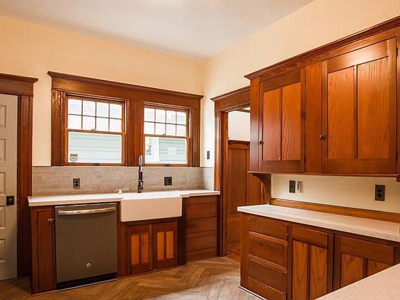 Renovated kitchen has farmhouse sink, new faucets, and all appliances, new countertops