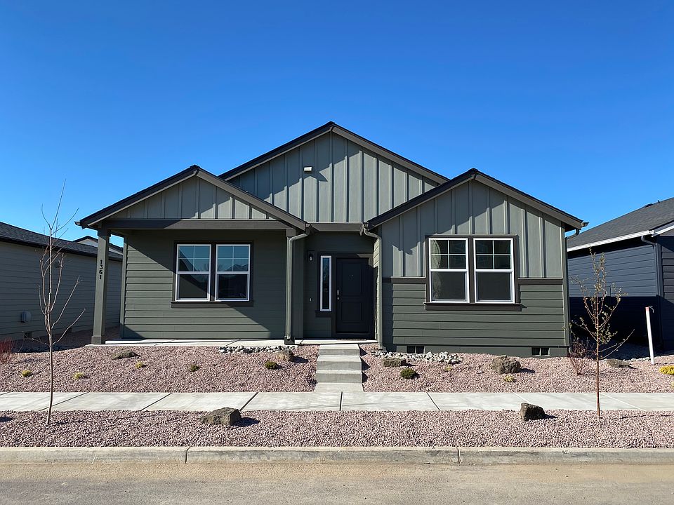Front yard of home with beautiful mountain views, low-maintenance landscaping, and covered front porch