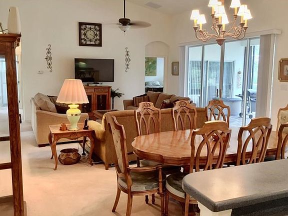 Great room with sliders to the lanai. Master bedroom entryway in the background.