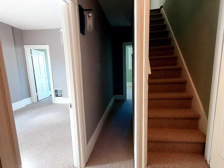 bedroom 2 on left, hall to main bedroom, stairway to 3rd floor
