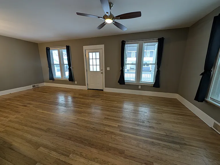 All windows have blinds and drapes
