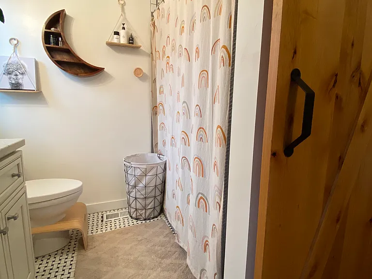 Bathroom 2 has floor to ceiling tile in a wall in shower