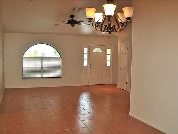 This photo is looking from dining area towards the front door.  There is tile throughout most of the home