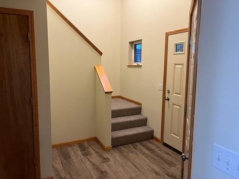 Main entry with stairs leading to upper level.