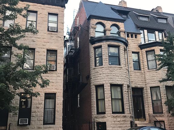 Street view of building (right side of gated alley).