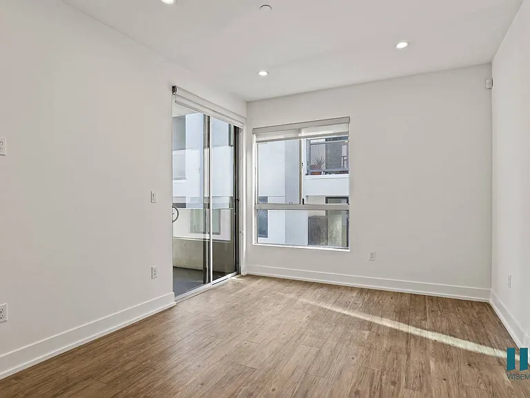 Living Room with Large-Size Windows, Patio, Recessed Lighting, and Vinyl Flooring